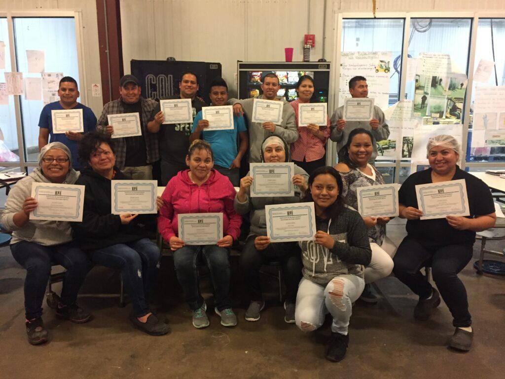 group of farmworkers with a certificate